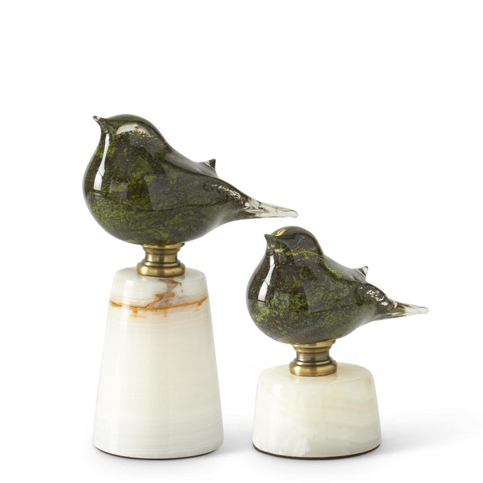 Set of two green glass bird figurines on white marble bases