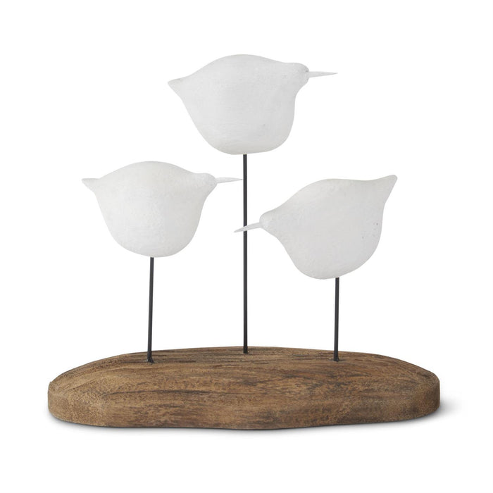 Three white seagull figurines on spindle supports and driftwood base