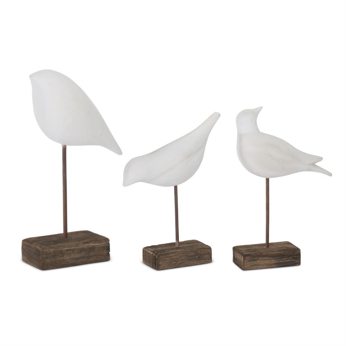 Set of three white wood shore bird figurines on spindle stands