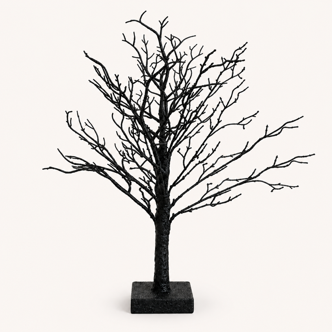 19-inch black spooky Halloween tabletop tree on a warm neutral catalog background