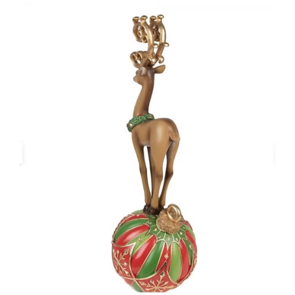 Reindeer on red and green ornament ball with holiday accents
