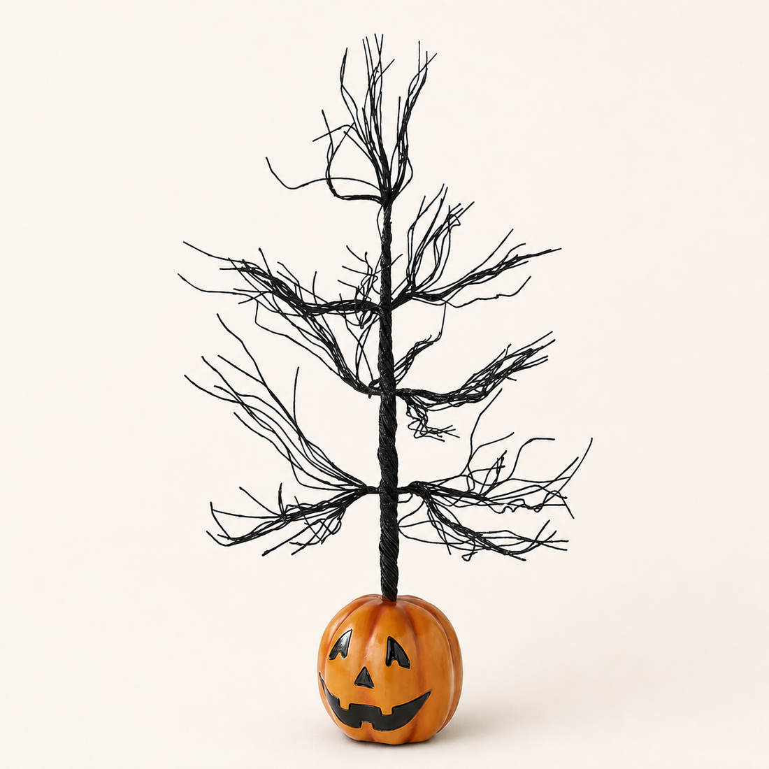 Black glitter Halloween tree with jack-o-lantern base on a neutral catalog background