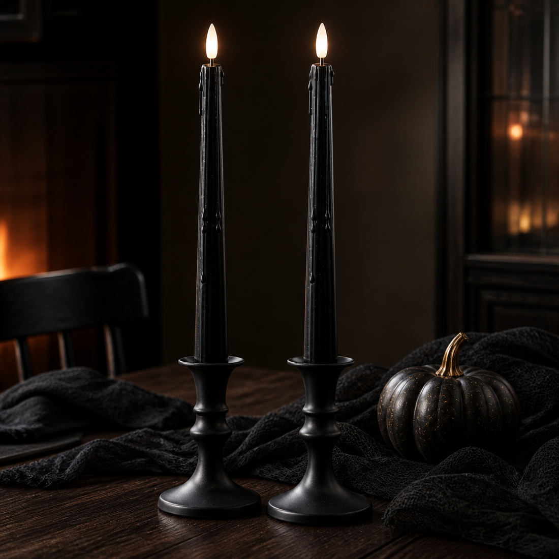 Two black LED drip taper candles styled on a dark Halloween dining table
