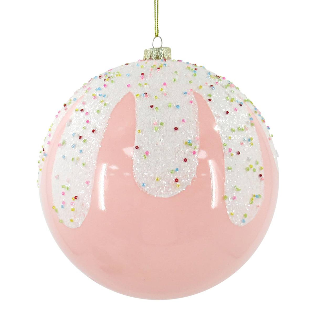 Pink Christmas ball ornament with white glitter icing and colorful sprinkles on white